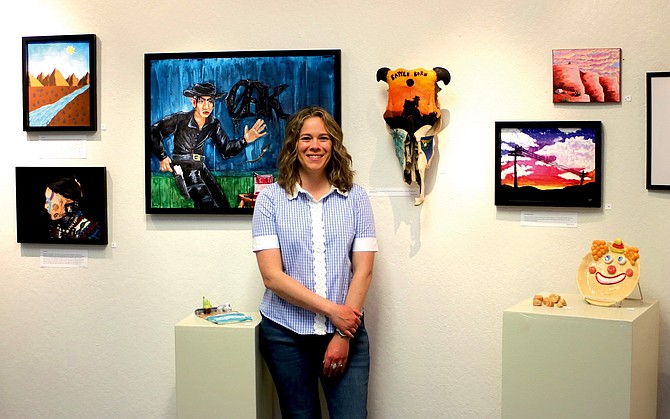 Churchill County High School teacher Amanda Hammond stands by her students’ art projects, which are now on exhibit at the Western Nevada College through April 21.