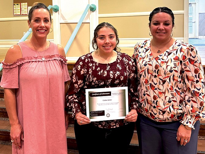 Churchill County Middle School student Colbie Keller is recognized by the school board for her participation in the Northern Zone Nevada Music Educators Association Honor Choir. From left: Trustee Julie Guerrero-Goetsch, Keller and Trustee Celestia Blakey.