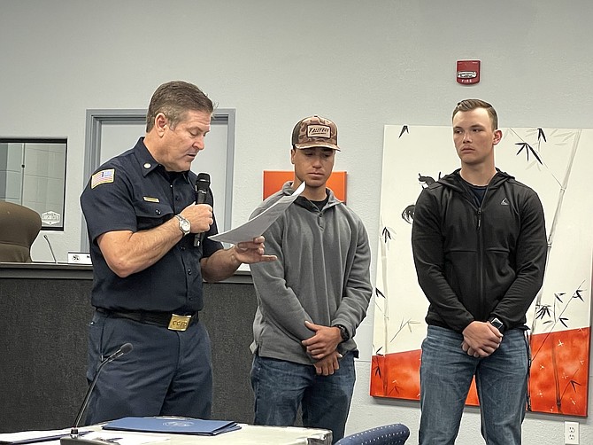 Carson City Fire Chief Sean Slamon, left, recognizes Robert Berger, center, and Lucas O’Brien, right, on April 17, 2025 for their help saving passengers in a Jan. 1 vehicle fire on College Parkway.
