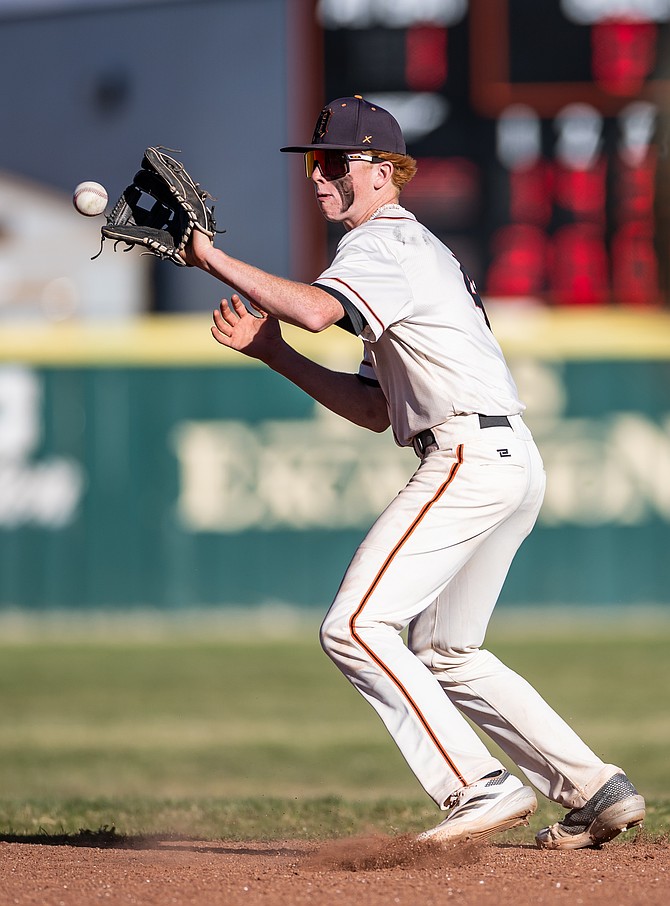 Douglas High’s Brock Tholen fields a ball at second base Thursday against Bishop Manogue.