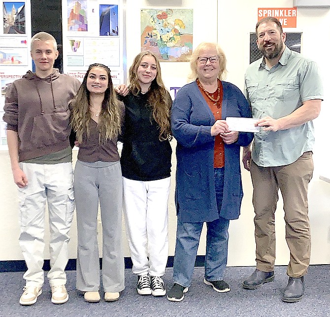 Whittell High School students Elias Beckwith, Aliana McLey, and Olivia Cranch, Sharon Hoelscher Day from Carson Valley Arts Council presenting check to art teacher Paul Lorion.