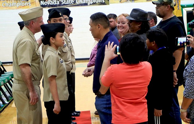 Parents and family members prepare to pin their students with next year’s rank.