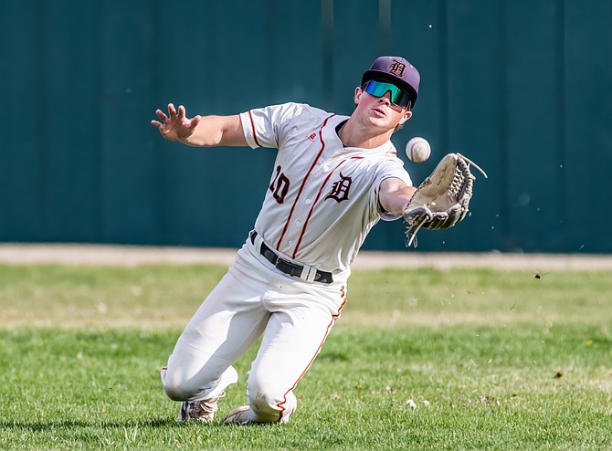 Douglas High’s Tyler Sentell charges in to make a diving catch against Damonte Ranch on Thursday. The Tigers won, 6-4.