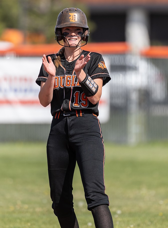 Douglas High junior Haylie Pledger claps on second base earlier this season. Pledger pitched a complete game against Carson High on Saturday, helping Douglas win and secure a No. 3 seed in the Class 5A North tournament.