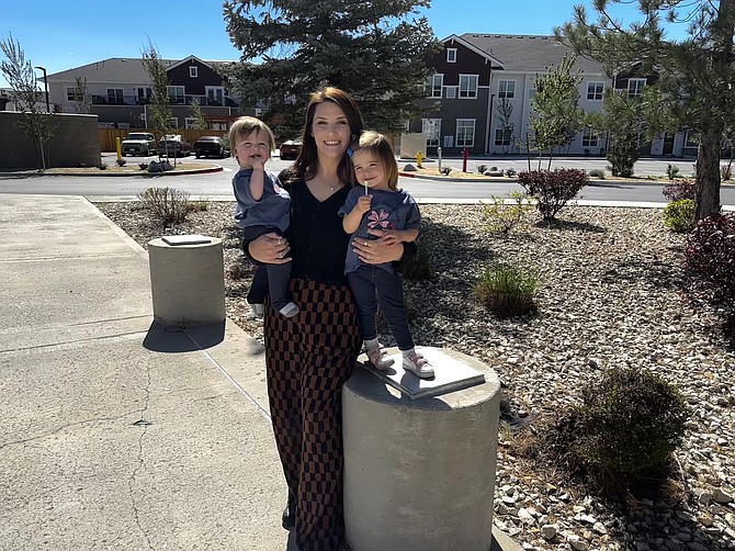 Katie Charleson, communications officer for Nevada Health Link, is a mother of four who has brought her two younger daughters, shown here, to the office.