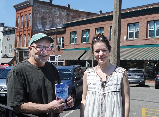 Malcolm Bates (left) and Taylor Russell show their newly published book “First Street Stories” while on First Street last week.