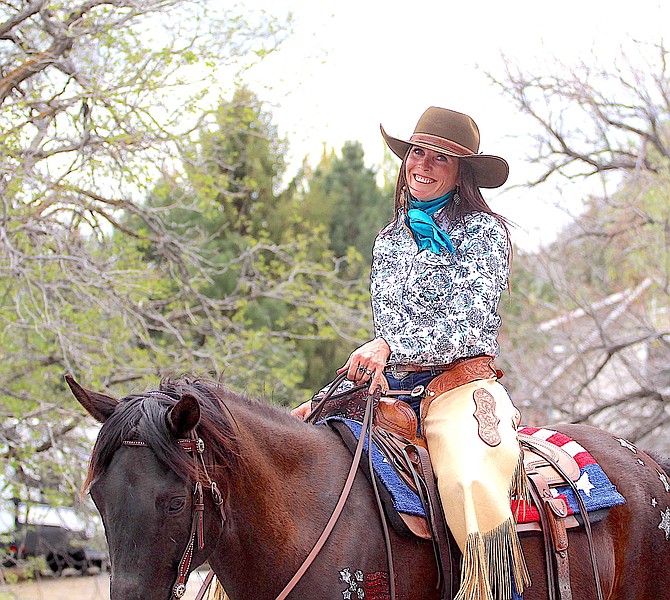Christy Lyons rides in Saturday's Invitational Horse Parade in Genoa. She was misidentified on Wednesday's opinion page.