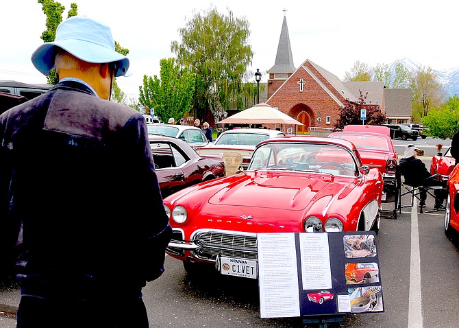 A visitor to the Holy Smokers Car Show admires Jim and Marilyn Smith's 1961 Corvette on May 3.