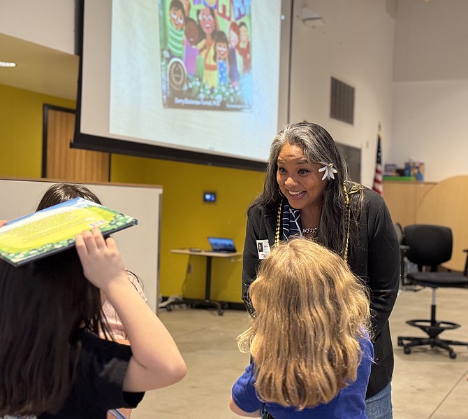 Gerry Ebalaroza-Tunnell engages with children at Horizon Elementary May 8 during her reading.