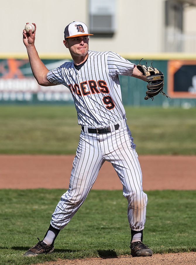 Douglas High School senior Jackson Ovard fields a grounder and throws to first during a game this season.