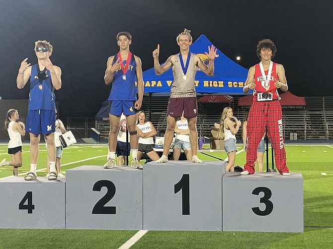 Dayton High’s Rhys Evans stands atop the podium after winning the Class 3A state title in the pole vault at Moapa Valley with a personal record of 15 feet.
