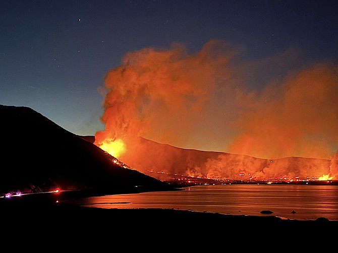 Flames are reflected in Mono Lake in this photo posted to the Inciweb Incident Information System.