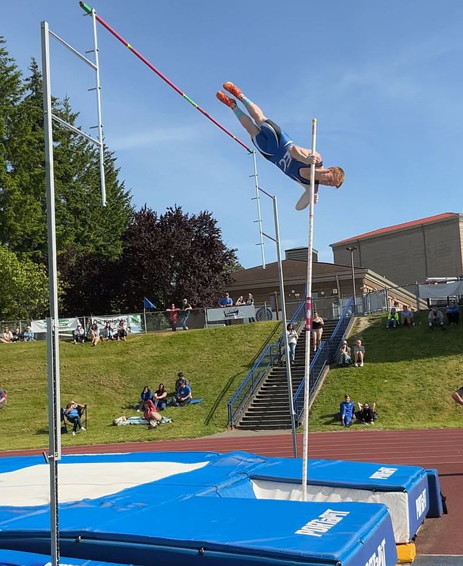 Eatonville's Ethan Carter soars his way to another 1st place finish in the pole vault last week at the district championships. Carter would claim the district crown with a vault of 15'0".