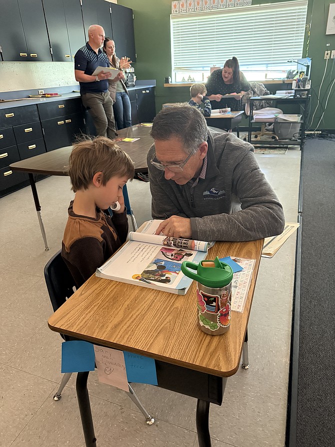 Superintendent Jay Brower reads with a first-grader.