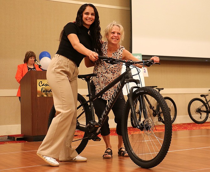 Carson High School senior Alexa Ponce Medina receives her bike from Supervisor Lisa Schuette as a congratulations for her attendance.