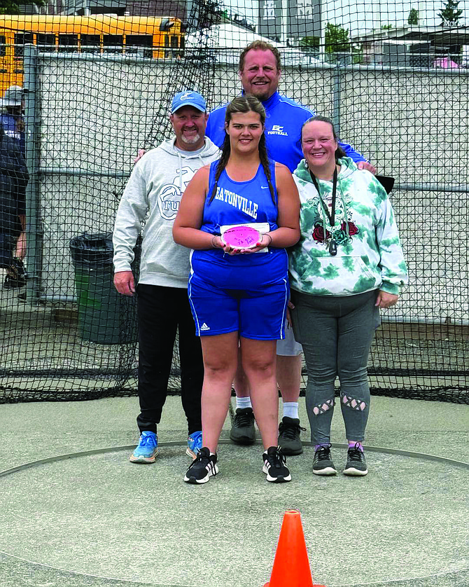Eatonville’s Taylor Johnson stands proudly with her coaches after winning the state championship in the discus. Pictured with Johnson are (from left) Coach Geoff Olson, Coach Wes Potter, and Coach Trinity Potter, celebrating a historic moment for Cruiser athletics.