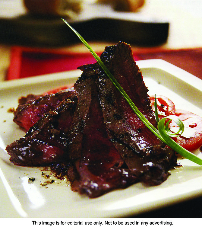 Flatiron steak and tomatoes with anchovy vinaigrette.