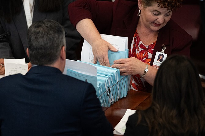 Legislation on the desk of Assembly Chief Clerk Bonnie Borda Hoffecker inside the Legislature on the final day of the 83rd session on June 2.