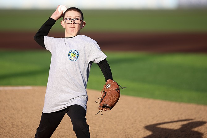 Blake Camus, 9, throws a ceremonial first pitch prior to the Everett AquaSox game against the Spokane Indians at Funko Field in Everett May 31 in honor of being a survivor of childhood heart disease.