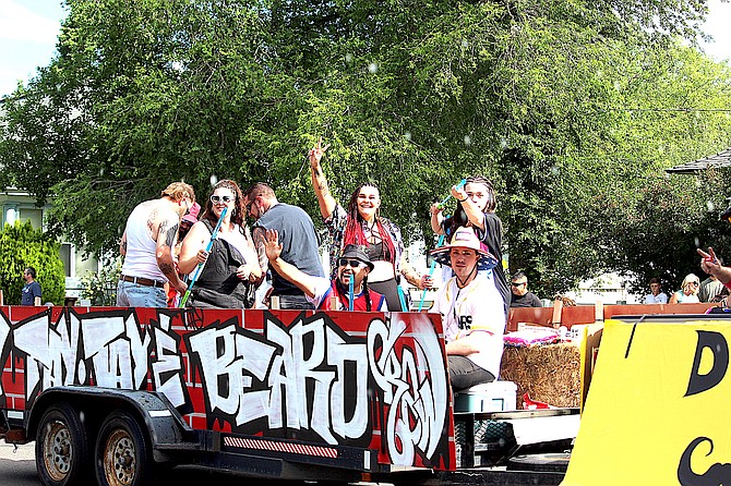 Taylor Lynch of Taylor’s Scissors and Clippers waves from her Carson Valley Days float in 2024 populated by the bearded and the not so bearded on their way to Tay Tay’s Beard Contest.