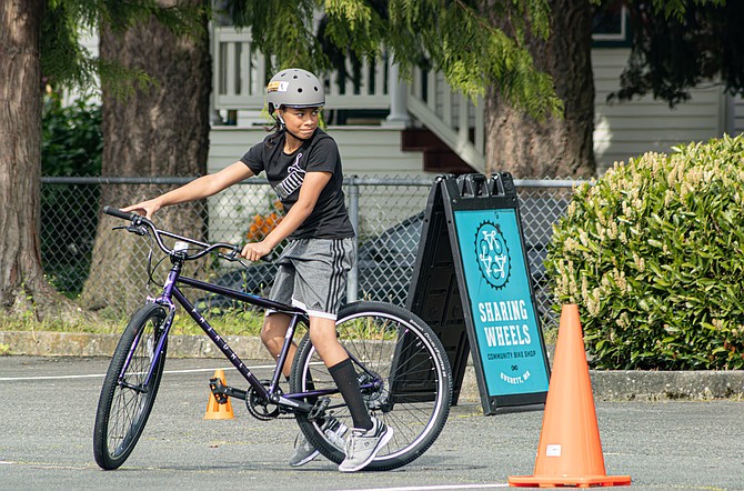 Kawehi Kaneaiakala waits for the signal to take a turn maneuvering an obstacle course set up by Sharing Wheels as part of the Youth Bike Club program.