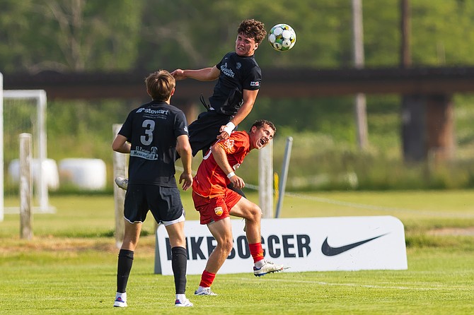 Snohomish United’s Carter Gay (leaping toward ball) during the Snohomish United USL2 match against Ballard FC Wednesday, June 11 at the Snohomish Stocker Soccer Fields. The game pitted the No. 1 and No. 2 teams in the league against each other. The final score was 1-1. 
The United made 15 shots on goal to Ballard’s 14, and made 10 corner kicks and 20 free kicks.