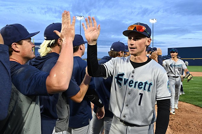 Everett AquaSox infielder Colt Emerson gives a high-five during the night game against the Spokane Indians at Avista Stadium in Spokane.