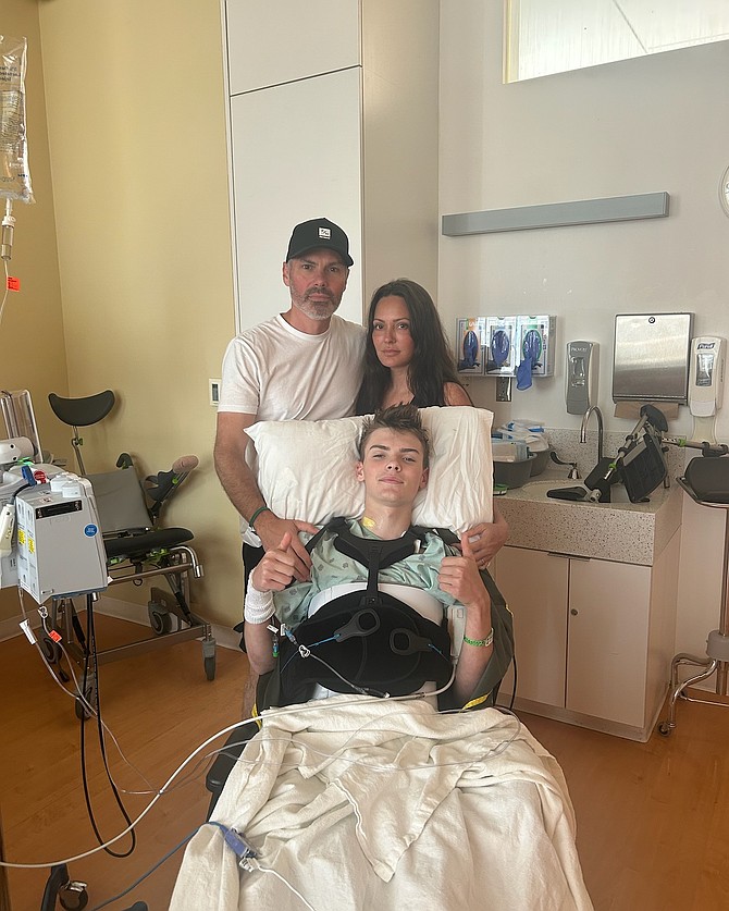 Jacob Badgley gives two thumbs up from his hospital bed after the accident.