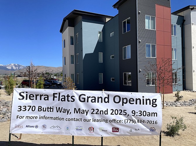 A banner with leasing contact information in front of the Sierra Flats affordable housing complex in Carson City on May 22, 2025.