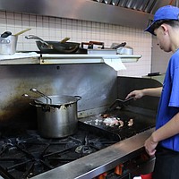 Tee Jay’s encourages Carson High student worker in kitchen