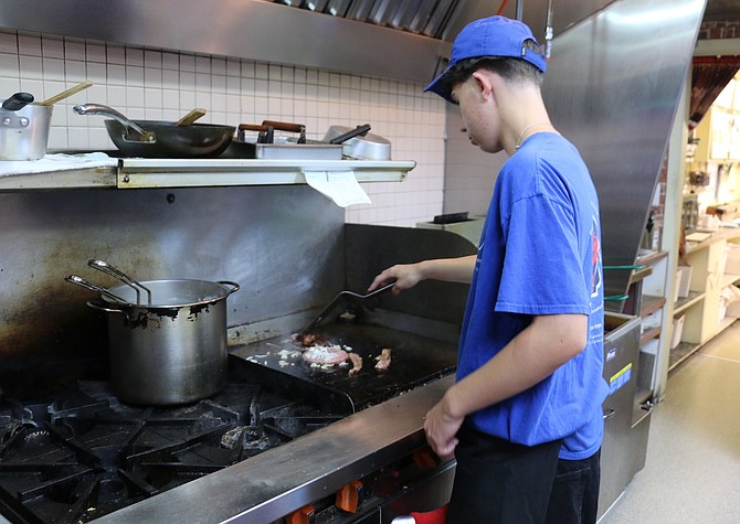 Carson High School student Nathan Jurek cooks in Tee Jay’s Corner Café and recently created his own dish, the Smashburger.