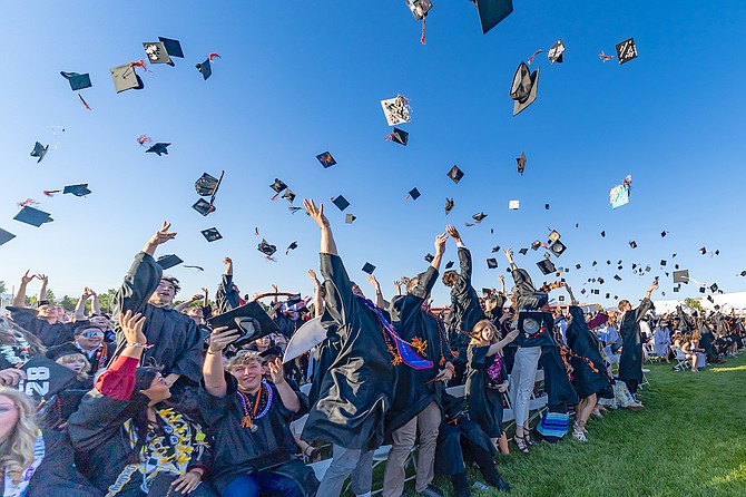 Hats fly at Douglas High School's graduation on June 12.