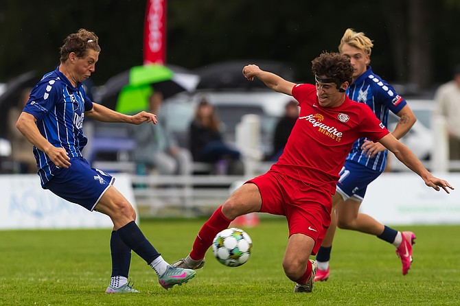 Snohomish United’s Eric Frintu tussles with a West Seattle Junction FC player at the June 26 match at Snohomish’s Stocker Soccer Fields.
The Snohomish United won 1-0 with a penalty kick being the final deciding score.