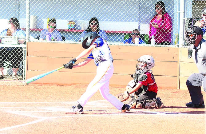 Winnemucca's Hayden Pommerening puts the ball in play against Lovelock during an 8-10-year-old game during the Nevada Little League District 3 all-star tournament in Winnemucca