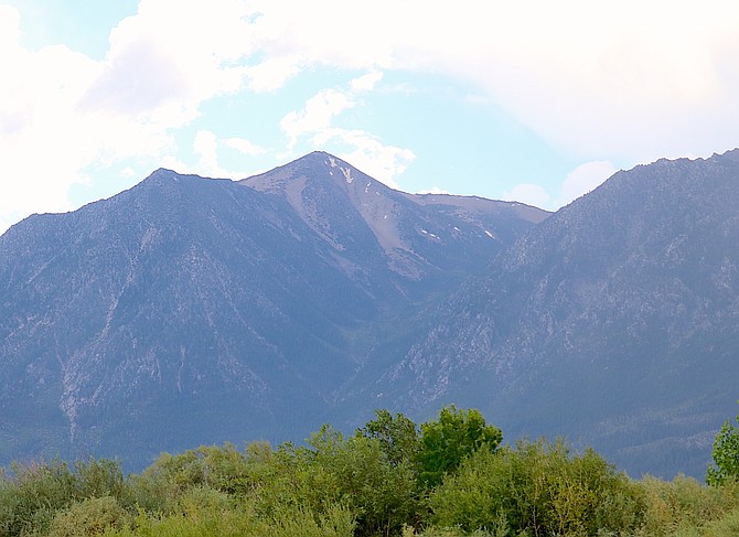 Tiny patches of snow cling to the north face of Jobs Peak on Wednesday afternoon.