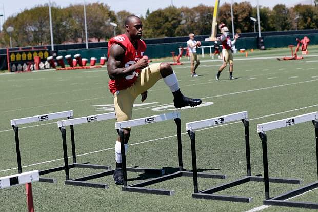 San Francisco 49ers tight end Vernon Davis jumps over hurdles during NFL football training camp on Thursday, July 25, 2013, in Santa Clara, Calif. (AP Photo/Marcio Jose Sanchez)