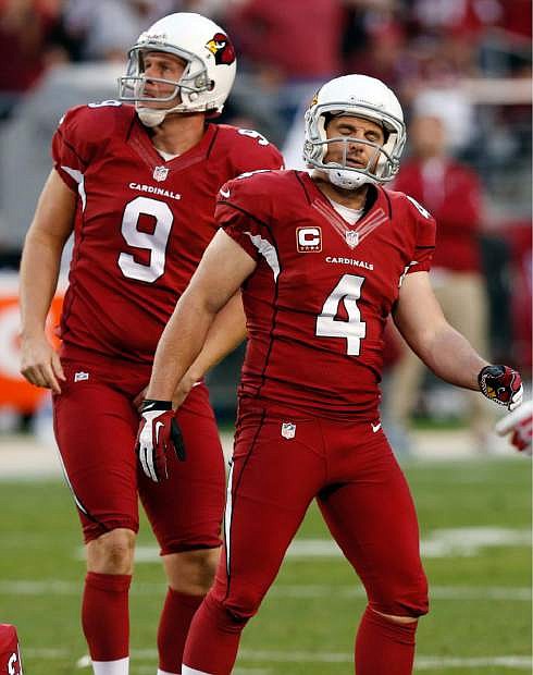 Arizona Cardinals kicker Jay Feely (4) stands on the field after he missed a field goal while teammate Dave Zastudil (9) is near during the second half of an NFL football game against the San Francisco 49ers, Sunday, Dec. 29, 2013, in Glendale, Ariz. The 49ers won 23-20. (AP Photo/Ross D. Franklin)