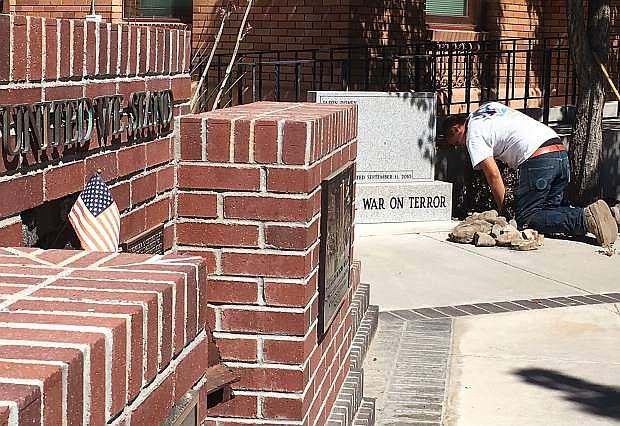 A city worker from the Parks Department spruces up the memorials for Sunday&#039;s 9/11 ceremony.
