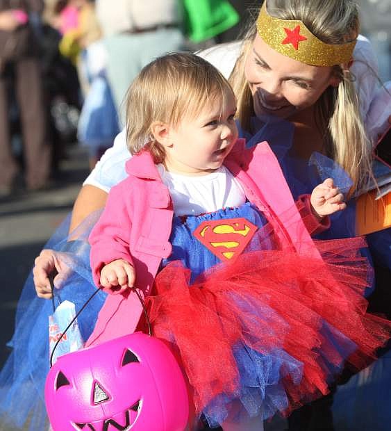 Sixteen-month-old Elsa and Shilo Smith, dressed as super heroes, watch the activity at the Spooktacular Stroll hosted by Carson Tahoe Regional Medical Center on Wednesday.