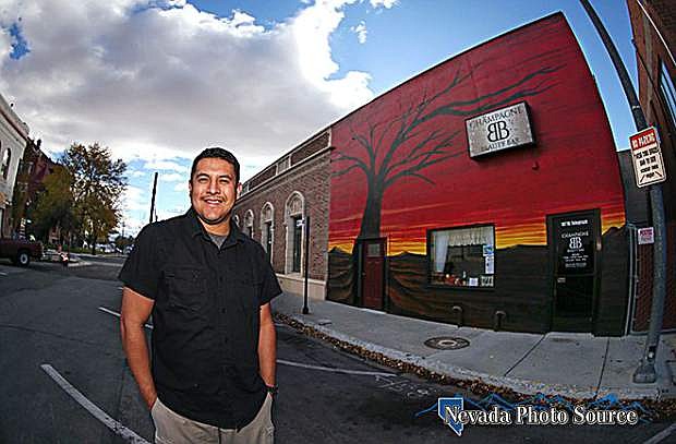 Artist Mauricio Sandoval poses with his Sunset Tree mural in downtown Carson City, Nev. on Tuesday, Oct. 25, 2016. The mural will officially be unveiled to the community during a ceremony 11:30 a.m. Friday.