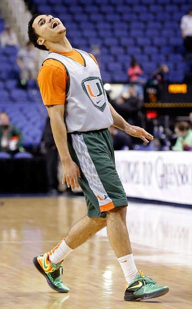 Miami&#039;s Shane Larkin reacts following a shot during practice for an NCAA college basketball game at the Atlantic Coast Conference tournament in Greensboro, N.C., Wednesday, March 13, 2013. (AP Photo/Gerry Broome)