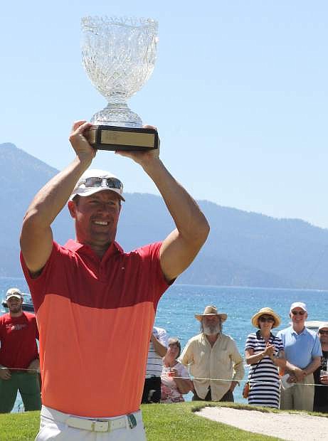 Former MLB pitcher Mark Mulder hoists the trophy after winning the 2016 American Century Championship on Sunday at Edgewood Tahoe Golf Course.