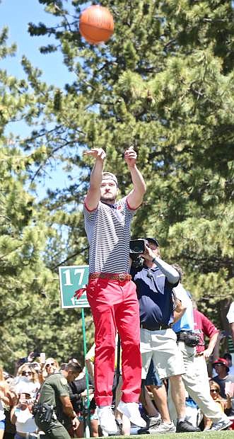 Not to be outdone by Steph Curry, Justin Timberlake takes a shot on a portable basketball hoop set up on the 17th tee Saturday at Edgewood Tahoe.