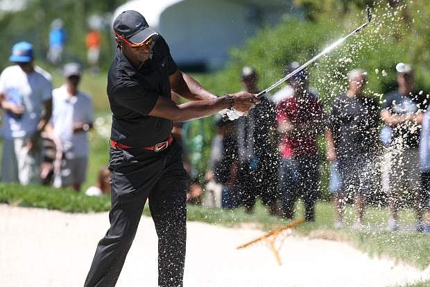 Jerry Rice hits a practice shot from the bunker at Edgewood on Tuesday.