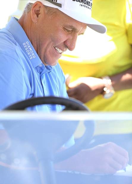 Mark Rypien a 2-time winner of the American Century Championship signs an autograph at Edgewood on Tuesday.