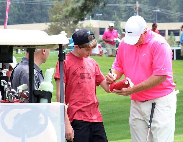Former National Football League quarterback Billy Joe Tolliver signs an autograph during Wednesday&#039;s Lake Tahoe Celebrity-Am Tournament at Edgewood Tahoe Golf Course.