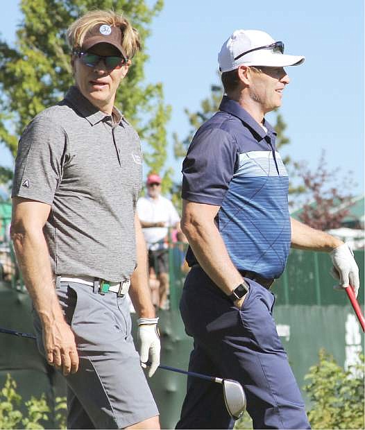 Actor Jack Wagner (left) and Hall of Fame quarterback Steve Young take off from the 10th tee at Edgewood Tahoe during a practice round.