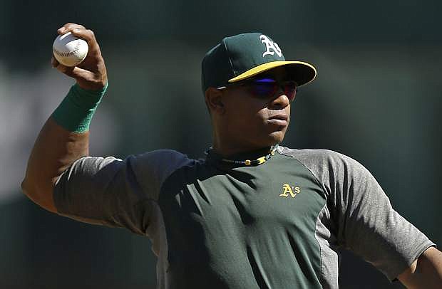 Oakland Athletics&#039; Yoenis Cespedes throws during a baseball workout on Thursday, Oct. 3, 2013, in Oakland, Calif. The Athletics are scheduled to host the Detroit Tigers in Game 1 of the American League division series on Friday. (AP Photo/Ben Margot)