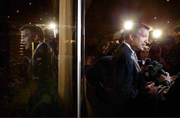Nevada Gov. Brian Sandoval speaks with members of the media at a Republican victory party Tuesday, Nov. 4, 2014, in Las Vegas. Sandoval defeated Bob Goodman to stay governor of Nevada. (AP Photo/John Locher)