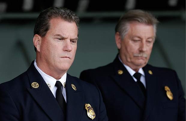 Foster City Fire Department Chief Michael Keefe, left, and Foster City Fire Investigator John Mapes listen to speakers at a news conference at the California Highway Patrol headquarters in Redwood City, Calif., Monday, May 6, 2013. Investigators are trying to determine why the back of a stretch limousine burst into flames on a San Francisco Bay bridge, trapping and killing five of the nine women inside on a girls&#039; night out, including a newlywed bride from the Philippines. It happened late Saturday night as the Lincoln Town Car crossed the San Mateo-Hayward Bridge on the south end of the bay. (AP Photo/Jeff Chiu)